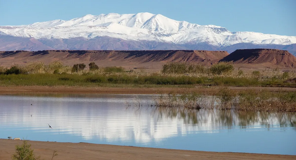 Water and ochre shores of Mansour Eddahbi reservoir near Ouarzazate