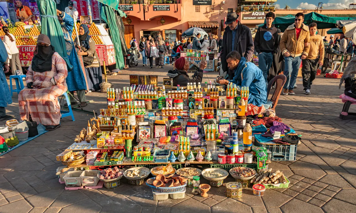 Colourful stalls and visitors at Jemaa el-Fnaa in Marrakech