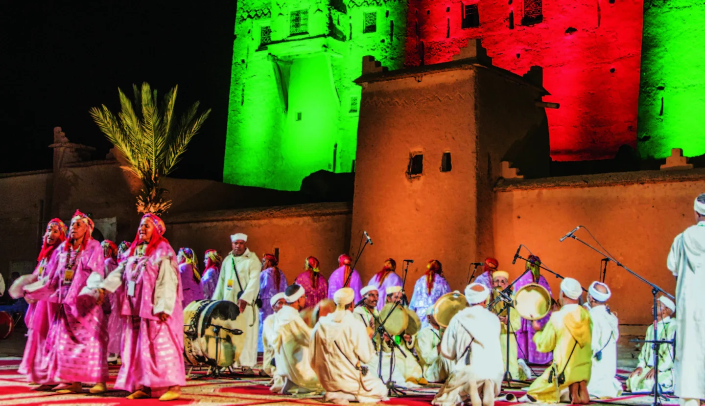 Ahwach performers in traditional dress on stage at Kasbah Taourirt.