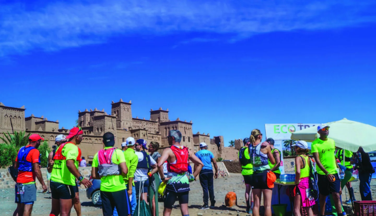 Runners gathered beneath the Eco Trail Morocco starting arch.
