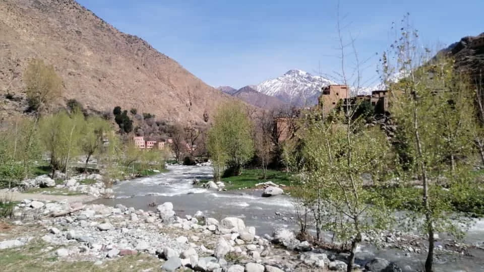 Tassaout River and snowy mountain peaks near Ichbaken
