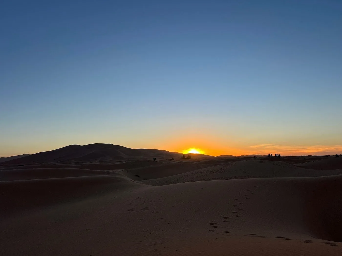 Sunrise over quiet desert dunes