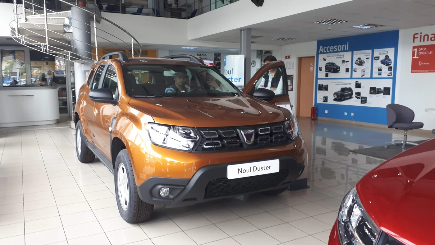 Orange Dacia Duster in a showroom