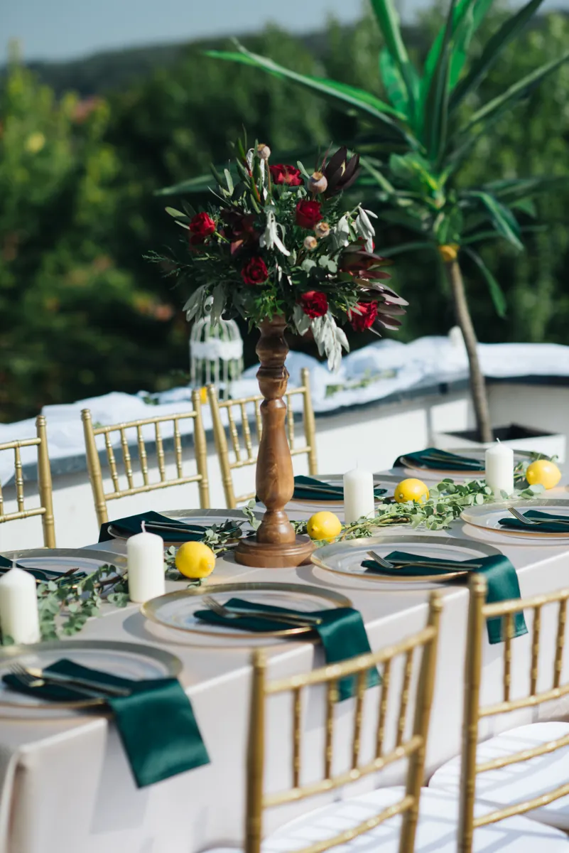 Reception table decorated with flowers, candles and elegant place settings